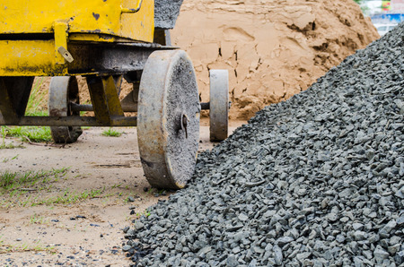 Cement mixer with sand and gravel mixing trough at a building site.の写真素材