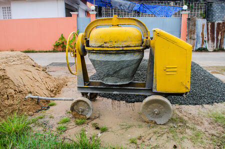 Cement mixer with sand and gravel mixing trough at a building site.の写真素材