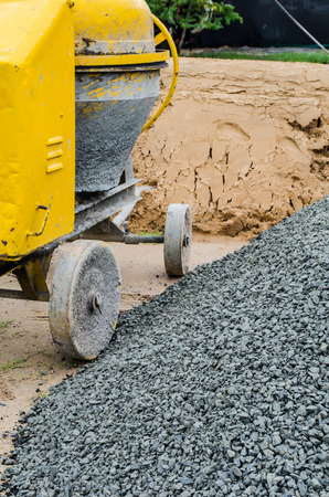 Cement mixer with sand and gravel mixing trough at a building site.の写真素材
