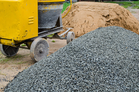 Cement mixer with sand and gravel mixing trough at a building site.の写真素材
