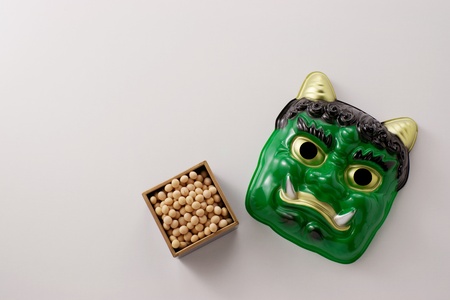 Japanese devils mask and japanese rosted beans of scattering ceremony at the beginning of springの写真素材