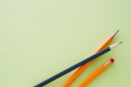 Three pencils on green backgroundの写真素材