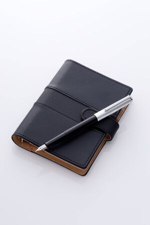 black pocket diary and penの写真素材