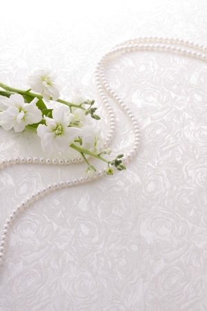small white flower and pearl on white clothの写真素材
