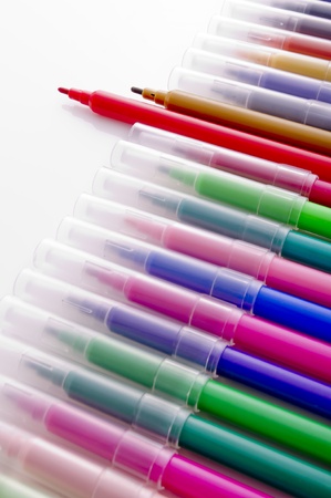 many colorful pens on the white background の写真素材