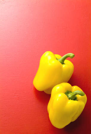 yellow paprika on red backgroundの写真素材