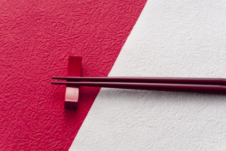 chopsticks on red and white japanese paperの写真素材