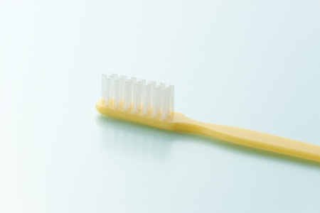 toothbrush on light blue backgroundの写真素材