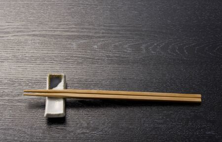 japanese chopsticks on wooden blackの写真素材