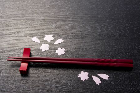 red chopsticks on wooden blackの写真素材