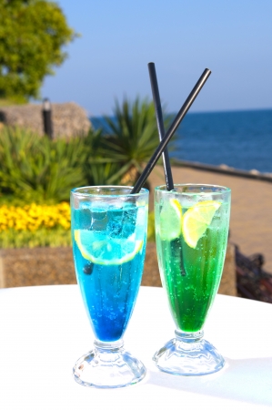 Two cocktails on table, sea backgroundの写真素材