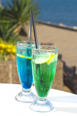 Two cocktails on table, sea backgroundの写真素材