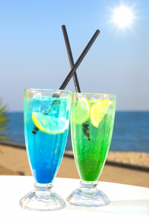 Two cocktails on table, sea backgroundの写真素材