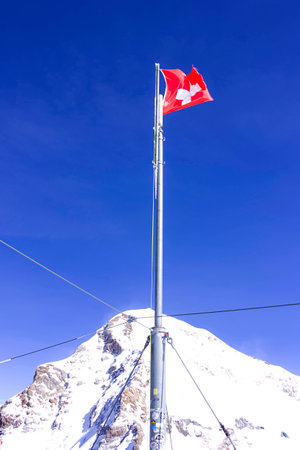 Swiss flag on the terrace with the view of Jungfrauの写真素材