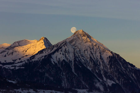 Moonlight setting in the swiss Alpsの写真素材