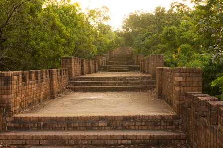 Old brick stairs leading to the bright end in the temple of Thailand