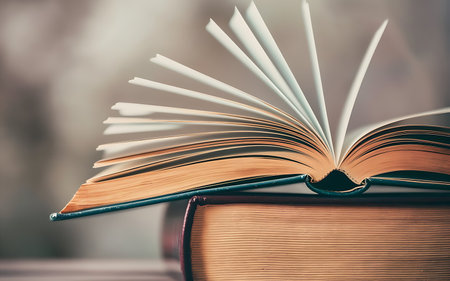 Book stack in the library and blurred bookshelf background for education. education background. back...