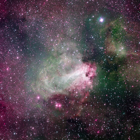Star-forming region Messier 17, also known as the Omega Nebula or the Swan Nebula. This vast region of gas, dust and hot young stars lies in Milky Way.の写真素材