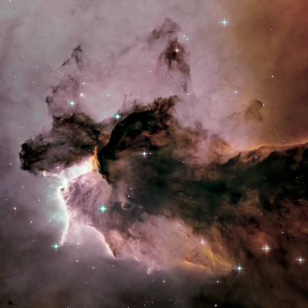 A billowing tower of gas and dust rises from the stellar nursery known as the Eagle Nebula. Space with stars, nebula and galaxy. Image with small DOF.の写真素材
