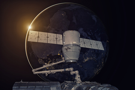 SpaceX Dragon orbiting the planet Earthの写真素材