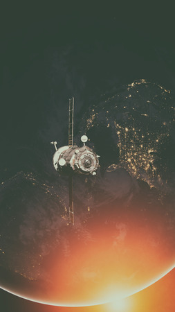 Spacecraft Progress orbiting the earth. Elements of this image furnished by NASA.の写真素材