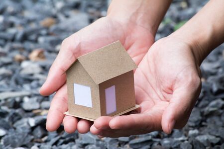 small house in the hands of a girlの写真素材