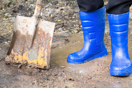 Farmer boots in the soil