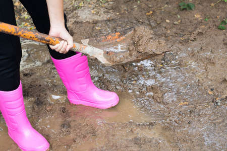 Farmer boots in the soilの写真素材