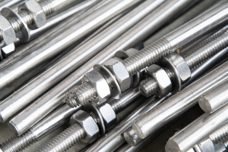Metal bolts and nuts close-up, industrial background, selective focusの写真素材