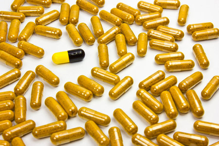 Yellow capsules on a white background. The concept of medicine and health.の写真素材