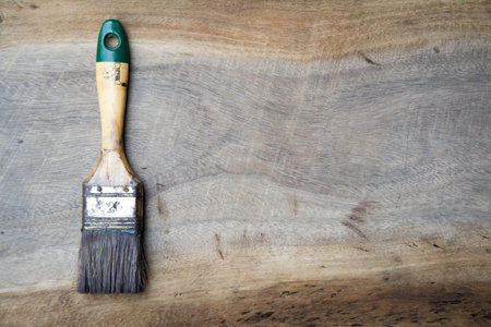 Paint brush on wood texture background with copy space for text.