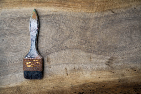 Old paint brush on a wooden background. Top view. Copy space.の写真素材