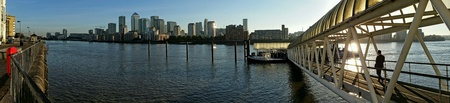 Panorama of London with worker boarding from Thames pier and city architecture