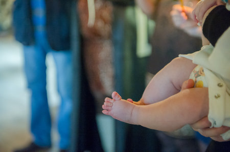 christening of little baby in church close-up feet