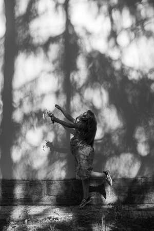 Shadow girl on an orange wall in summer