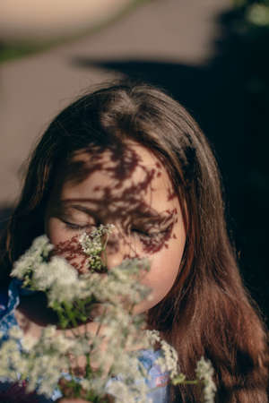 Shadow girl on an orange wall in summerの写真素材