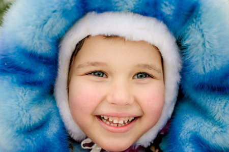 girl walking around outdoors in the winter, playing with snowの写真素材