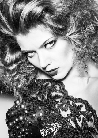 Beauty young woman with curly big and long hair. Permed hair. Glamour lady, Beautiful Woman Portrait. redhead Wavy Hair, perfect make up, red lips, thick eyelashes.の写真素材