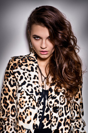 Girl in leopard blouse possing ia studioの写真素材