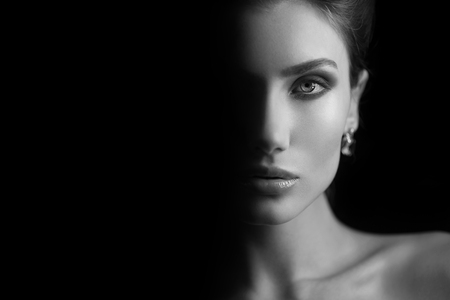 Girl at black background. Photo in black and white style.の写真素材