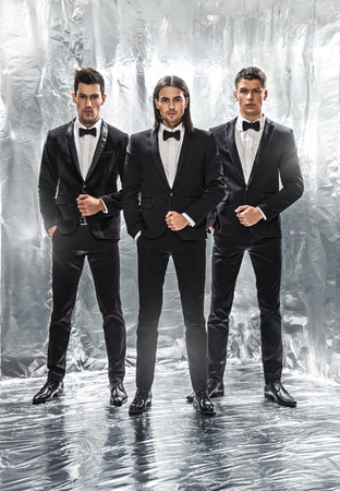 Full length portrait of a confident business team standing on a silver backgroundの写真素材