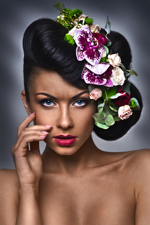 Beautiful woman with wreath of flowers. Isolated on green background.の写真素材