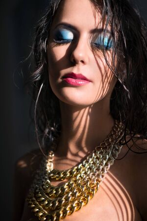 Beautiful woman with jewelry and beauty blue make up.の写真素材