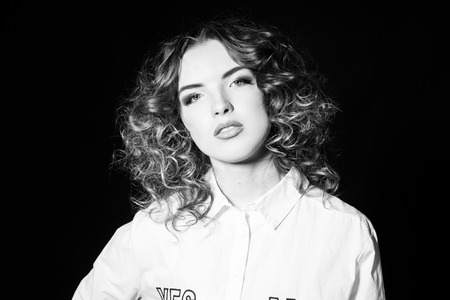beautiful girl with curly hair. Black and white photo