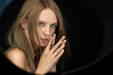 Beautiful woman with professional make up and hairstyle in studio