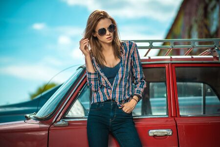 Cheerful happy lady caucasian middle age standing near retro red car