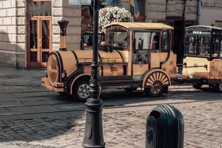 Yellow touristic Train in old city. Old locomotiveの写真素材