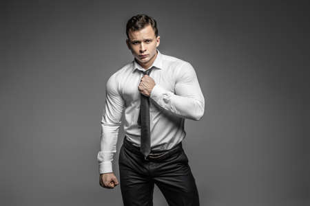 Strong and elegant young man possing in studioの写真素材