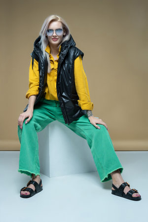 Fashion model girl posing in fashionable clothes in studio. Casual style, beauty accessories. High fashion urban styleの写真素材