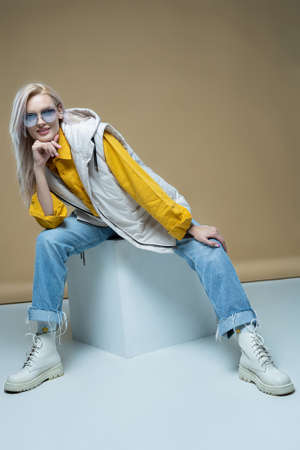 Fashion model girl posing in fashionable clothes in studio. Casual style, beauty accessories. High fashion urban styleの写真素材